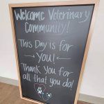 A blackboard with welcome veterinary community written on it.