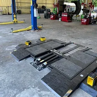 A blue and yellow lift is sitting in a garage