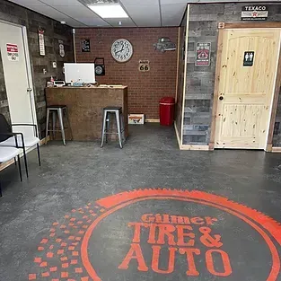 A room with a sign that says gilmer tire & auto