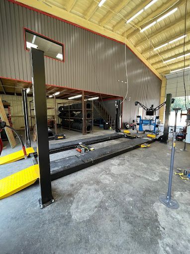 A garage with a lot of equipment and a lot of windows.