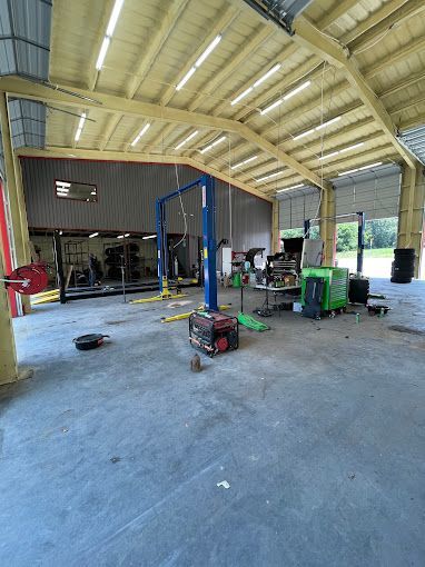 A large garage with a lot of equipment in it.