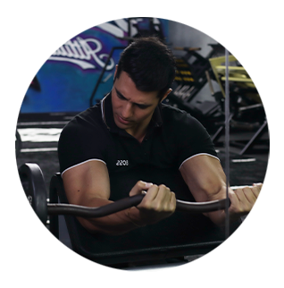 A man in a black shirt is lifting a barbell in a gym