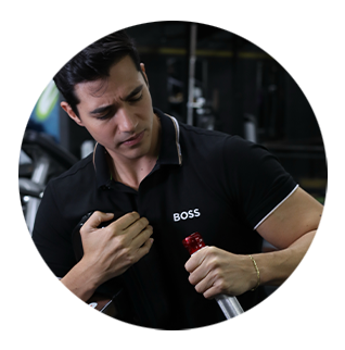 A man wearing a black shirt with the word boss on it