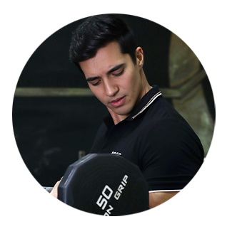 A man in a black shirt is holding a 50 pound dumbbell