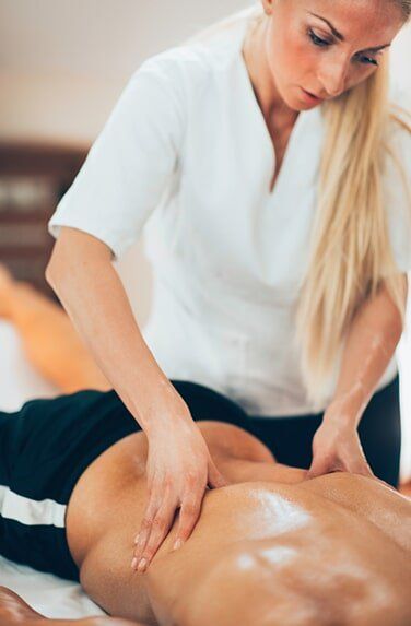 Massage Of Lower Back — Muscle Pain Solutions in Hamilton, NSW