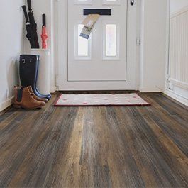 Kitchen with navy blue cabinets, stainless steel appliances, white countertops, and hardwood floors.
