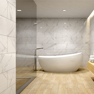 Modern bathroom with a white tub, marble-look tiled walls, and wood-look floors.