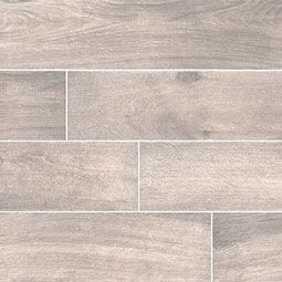 Gray wood-look tile flooring, with varying lengths and grain patterns, laid in a staggered pattern.