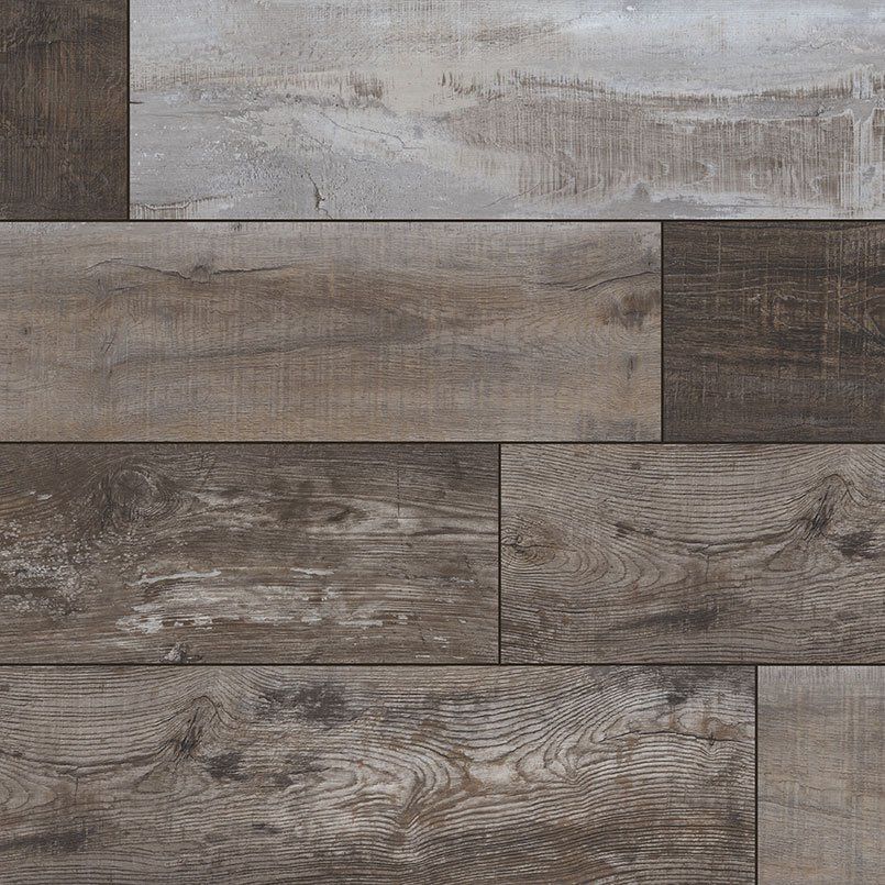 Close-up of weathered wood flooring in shades of brown, gray, and white, arranged in a rectangular pattern.