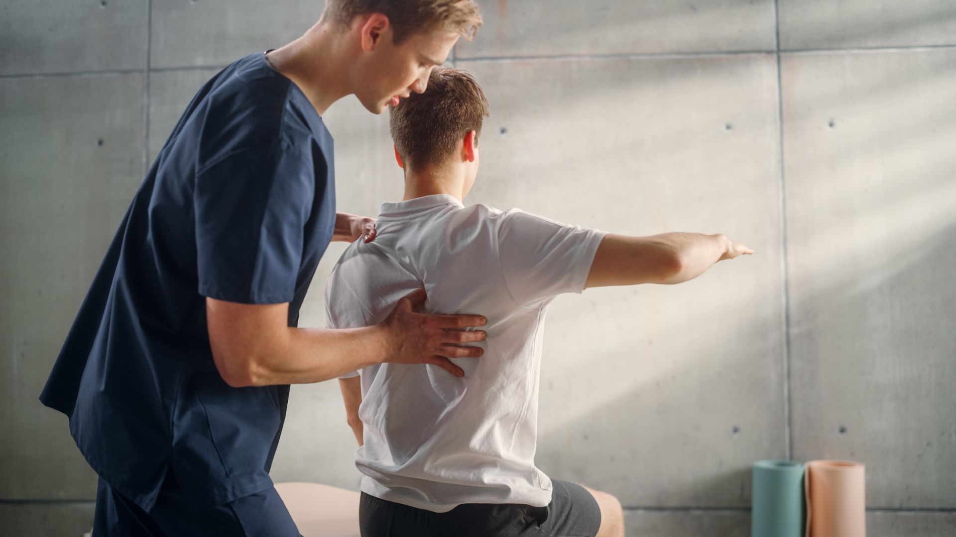 A man is giving a man a massage on his back.