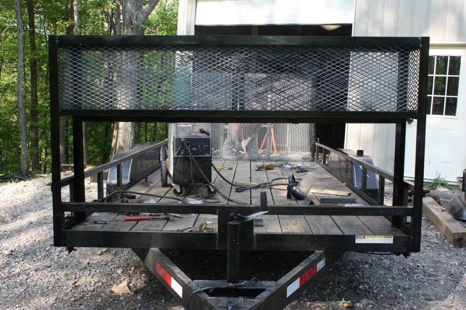 A trailer with a fence on the back of it