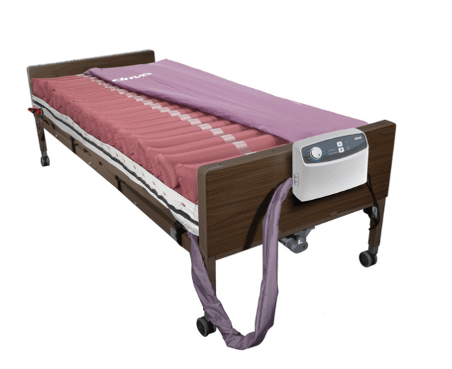 A hospital bed with a purple mattress and a hose attached to it.