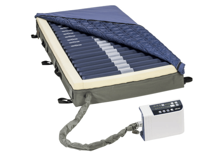 A mattress with a pump attached to it on a white background