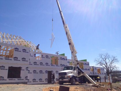 helton's Tree Crane lifting rafters over new construction Shelton's Tree Crane lifting rafters over new construction