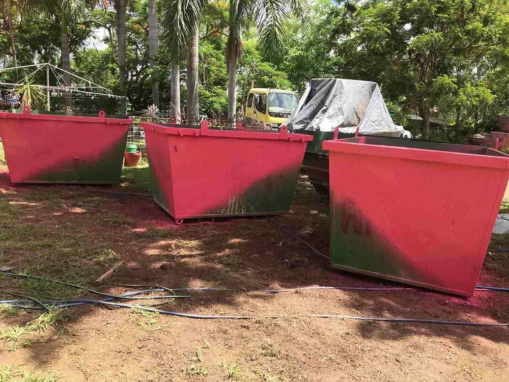 Three Purple Pink Dumpsters On Top Of A Dirt Field — Kanga Bins Qld Pty Ltd In Mulara, QLD