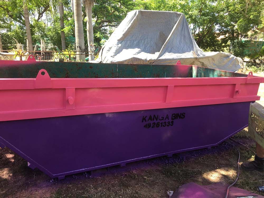 Kanga Bins Pink And Purple Dumpster On The Ground — Kanga Bins Qld Pty Ltd In Mulara, QLD