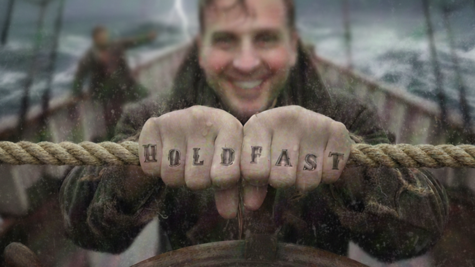 Jason Nangle gripping a rope at a ship’s wheel in a storm, showing a “Hold Fast” tattoo.