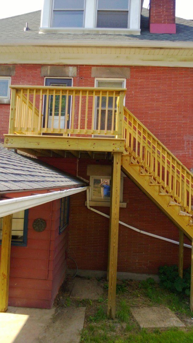 Staircases — Orange House With Yellow Railings in Slippery Rock, PA