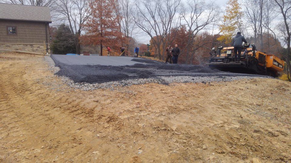 Driveways Service — Workers Putting Asphalt in Slippery Rock, PA