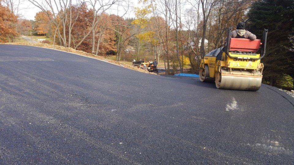 Driveways — Flatting The Asphalt With Roller in Slippery Rock, PA