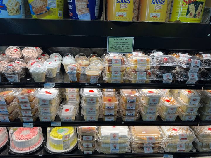 A display case filled with lots of different types of cakes.