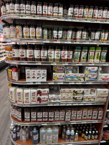 A pantry filled with jars , baskets , and bottles.