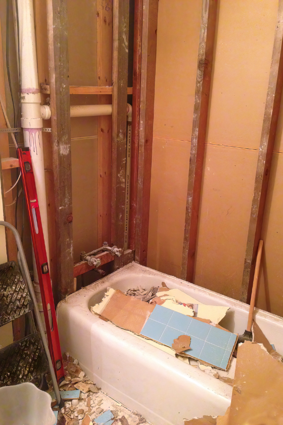 A bathtub is being remodeled in a bathroom.