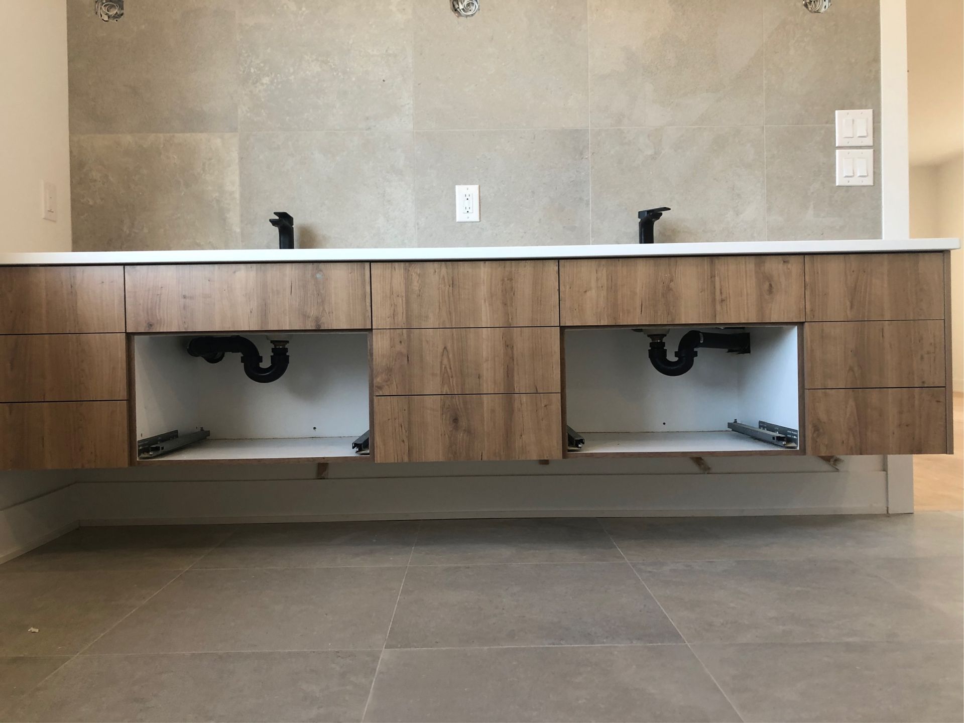 A bathroom with two sinks and a mirror