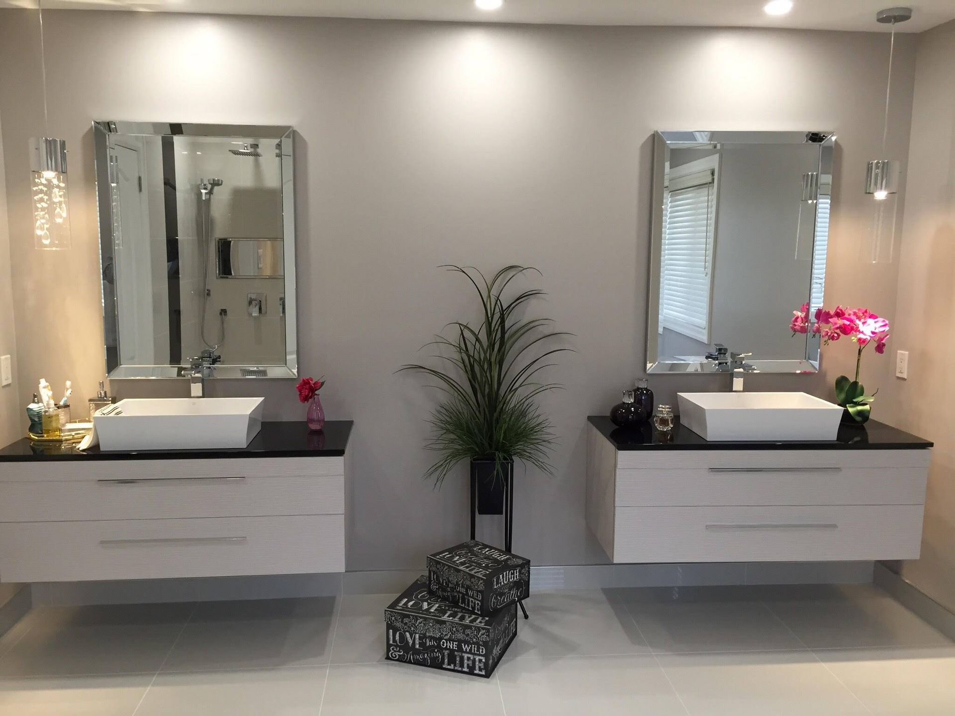 A bathroom with two sinks and two mirrors