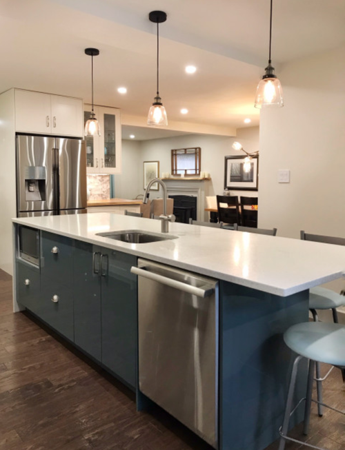 A kitchen with stainless steel appliances and a large island