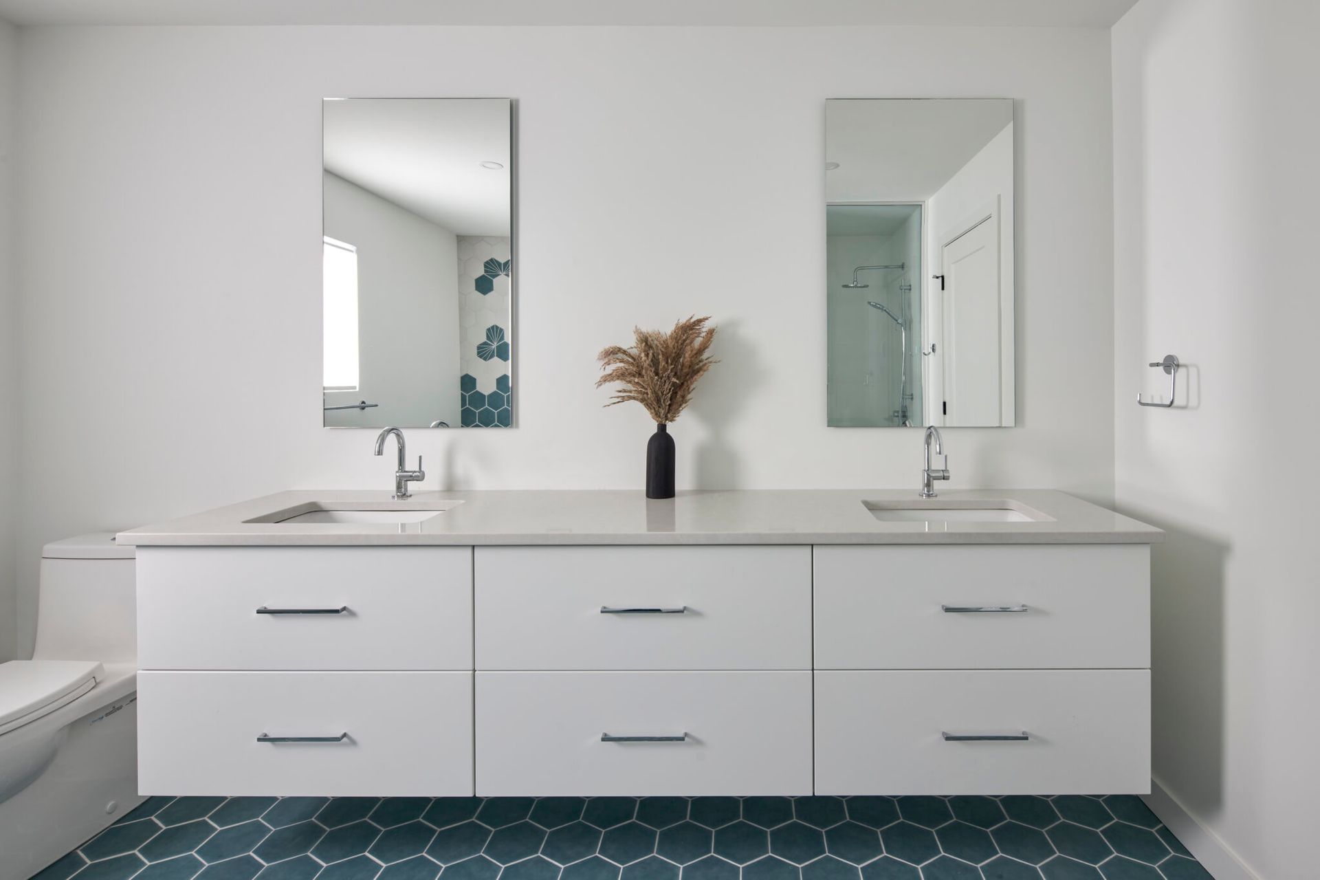 A bathroom with two sinks and two mirrors.