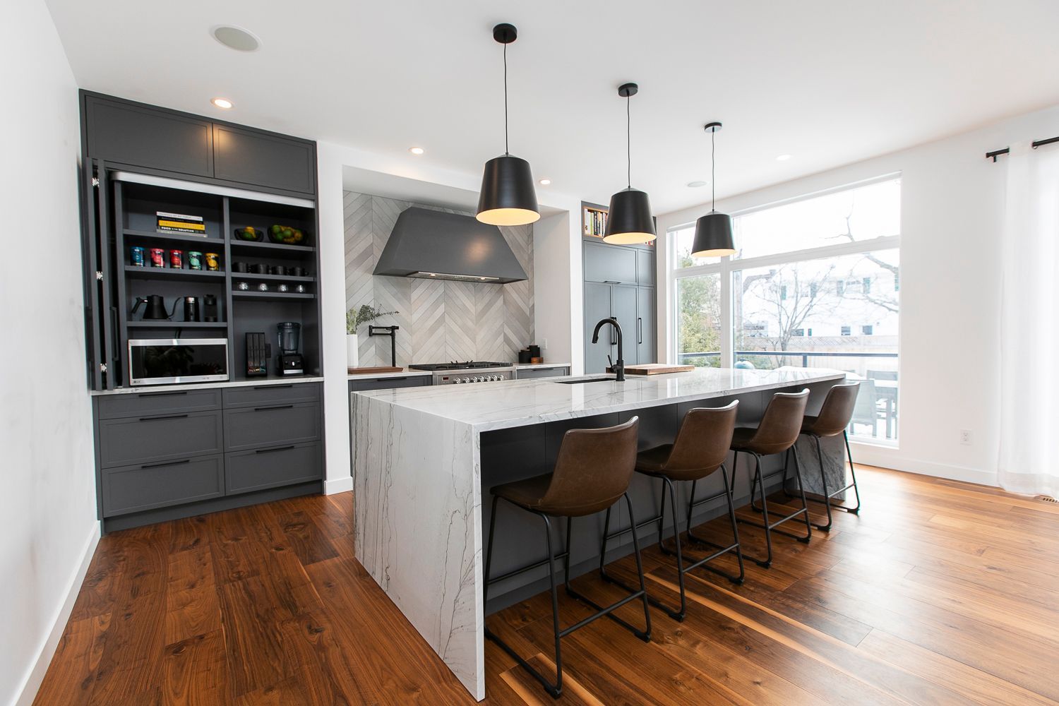 There is a large island in the middle of the kitchen.