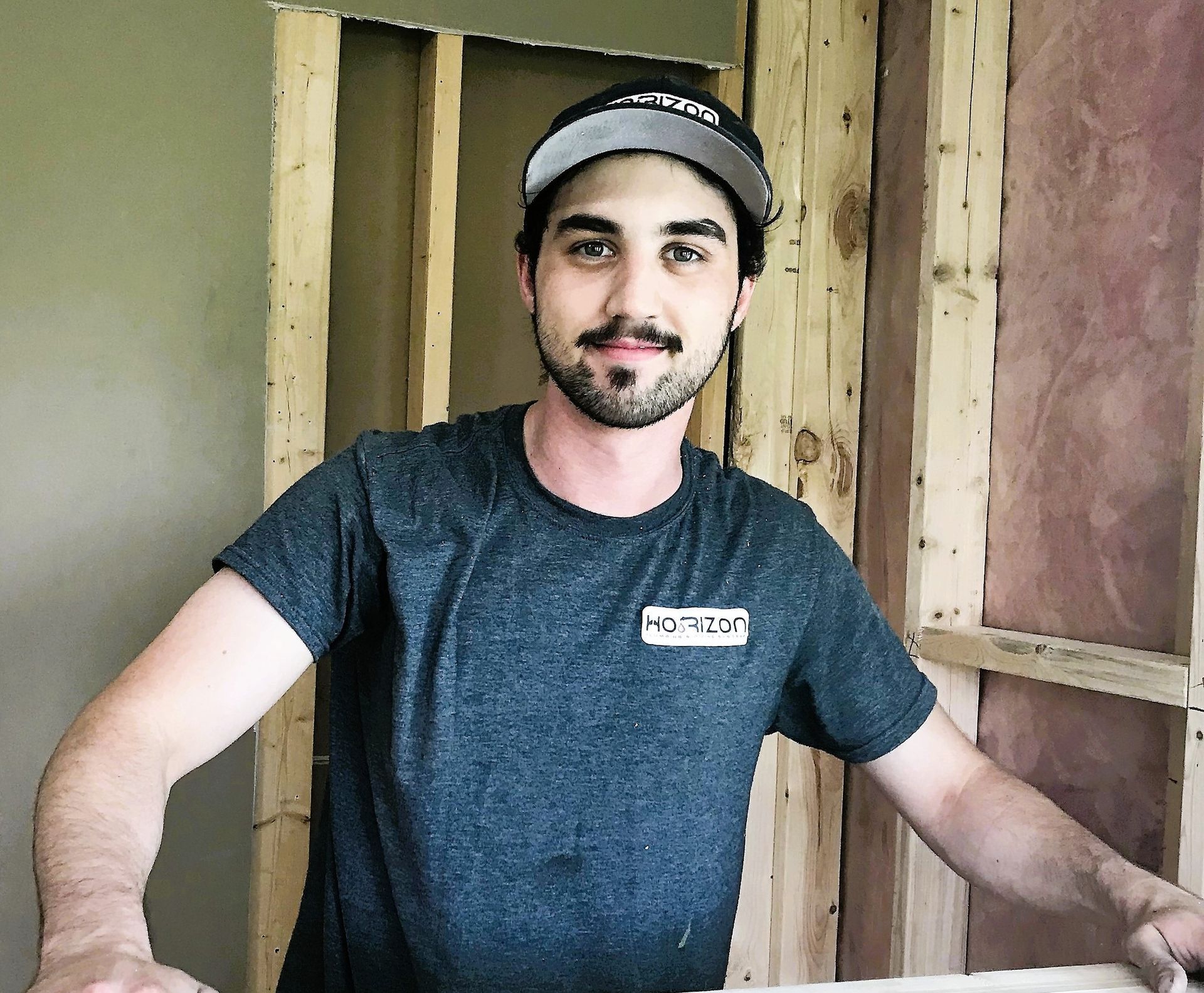 A man wearing a hat and a t-shirt that says ' o'reilly ' on it
