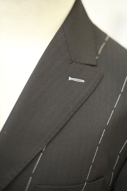 Peaked lapel with light grey button hole on black