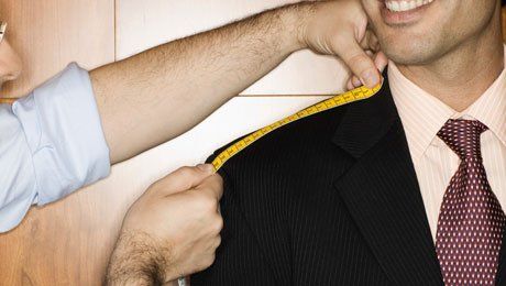 measuring customer for tailored suit