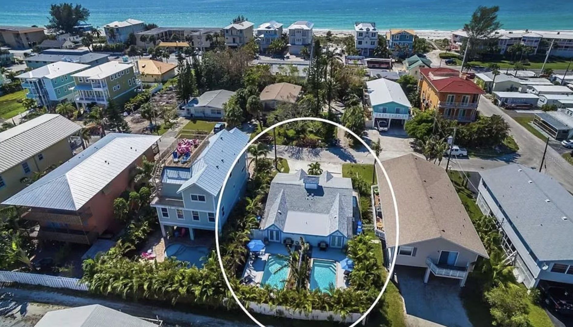 An aerial view of a house with a pool in the middle