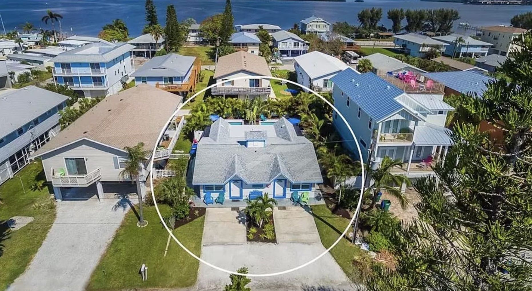An aerial view of a residential area with a house in the middle.