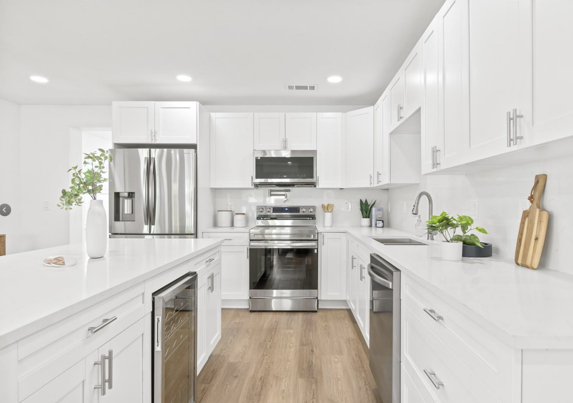 A kitchen with white cabinets and stainless steel appliances.