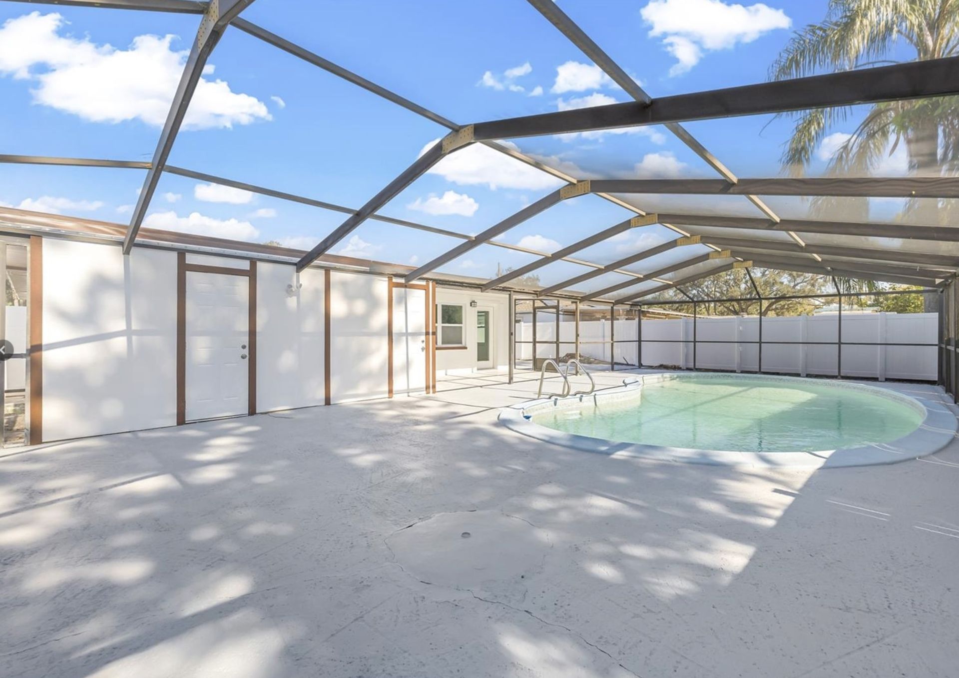 A large indoor swimming pool with a clear roof