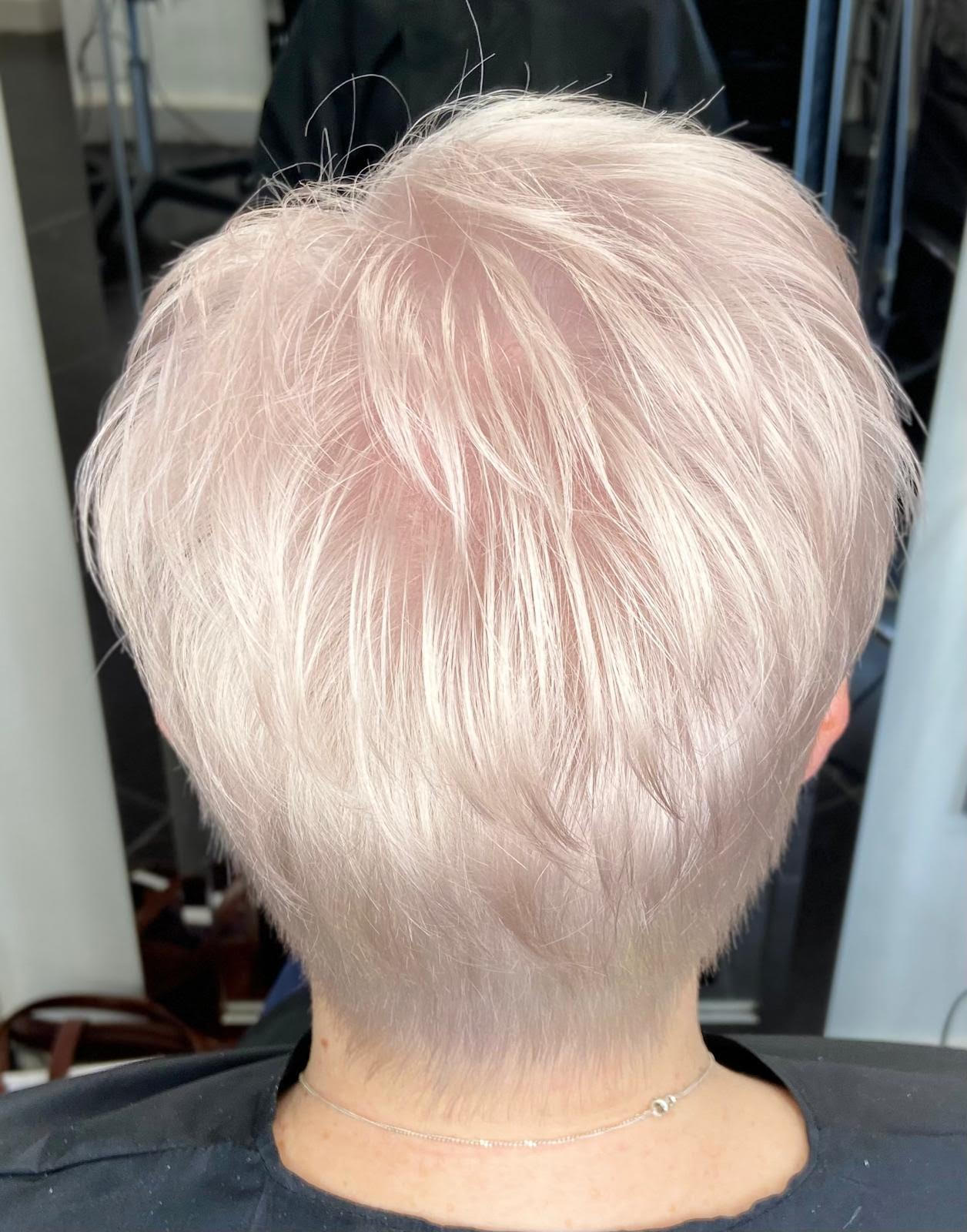 Close-up of short, pale pink-blond hair from the back, showing a tapered nape.