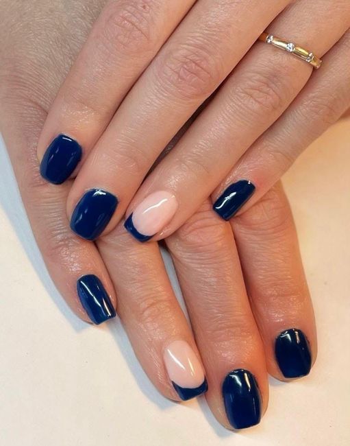 Two manicured hands with pale pink nails and a diamond ring on a white background