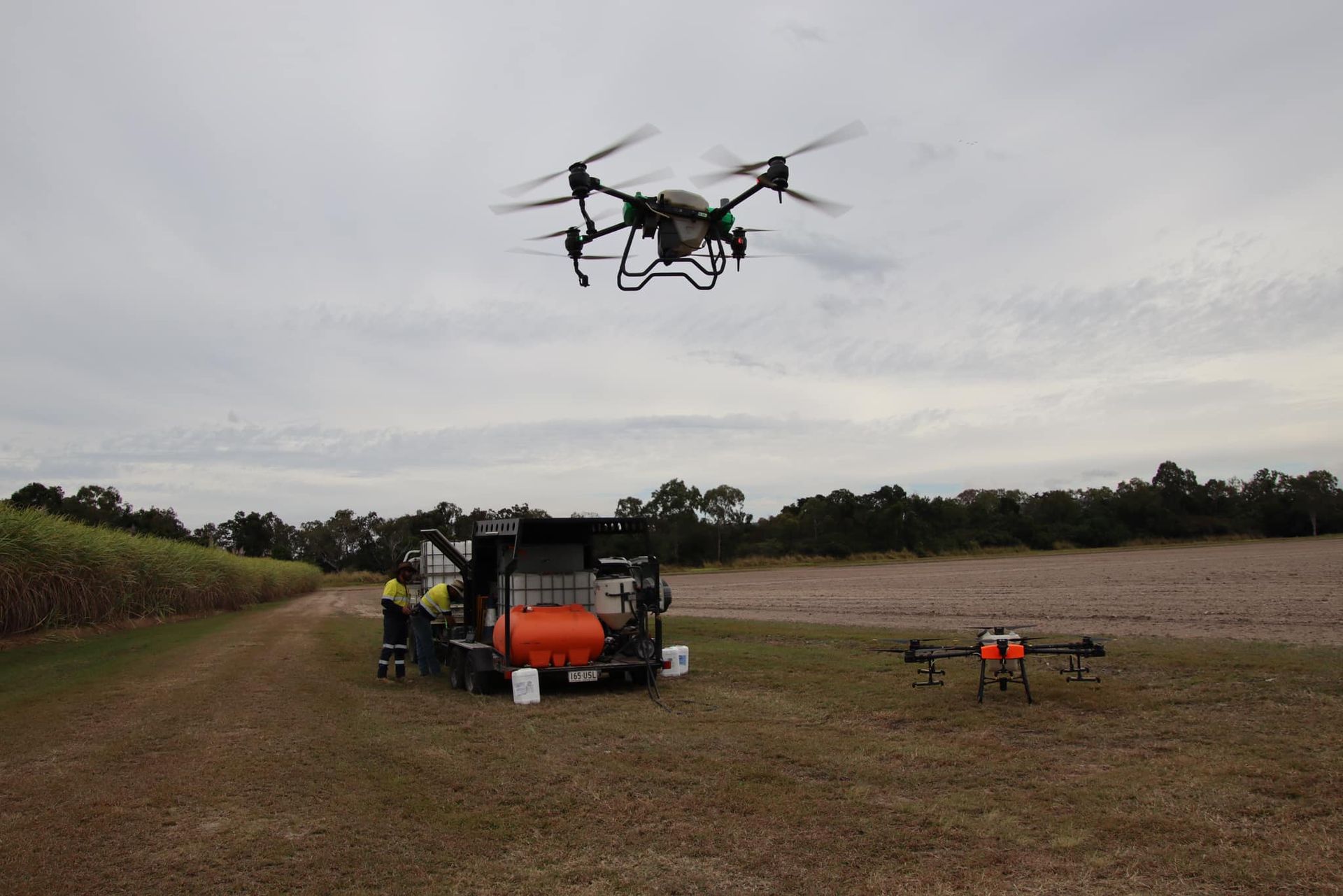 Drone Spraying Chemicals Above a Field, Near a Truck, on A Cloudy Day — Jetstream Aerial Services in Te Kowai, QLD