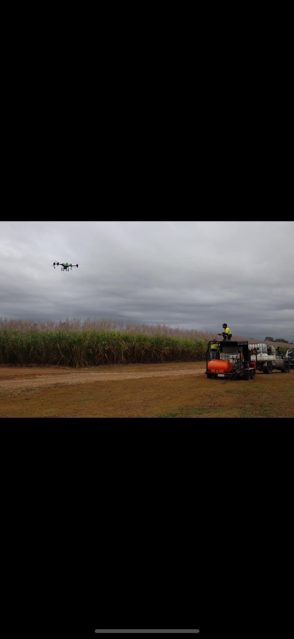 Drone Flying Over a Field with A Tractor and Rv Under a Cloudy Sky — Jetstream Aerial Services in Te Kowai, QLD