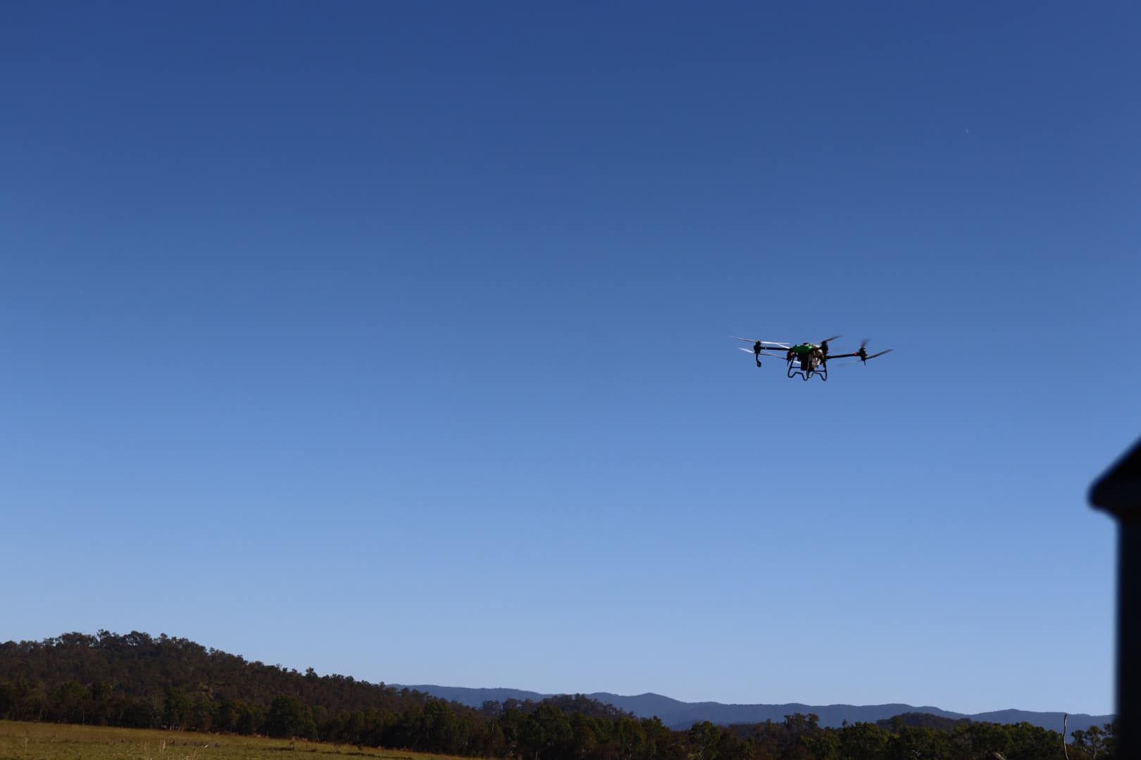 Drone Flying in A Blue Sky Over a Landscape of Hills and Trees — Jetstream Aerial Services in Te Kowai, QLD