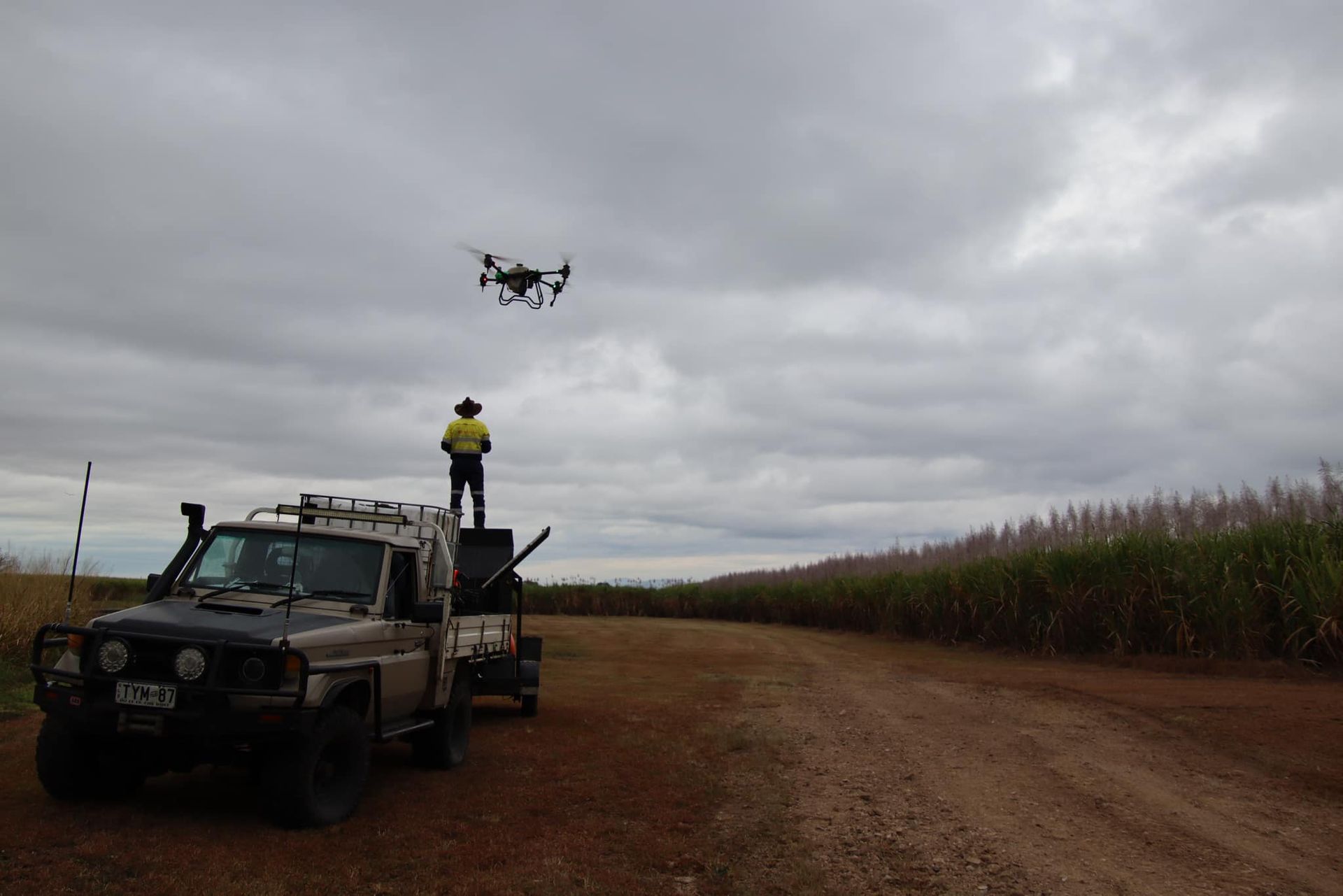 Man Operating a Drone from A Truck in A Field, Under Cloudy Skies — Jetstream Aerial Services in Te Kowai, QLD