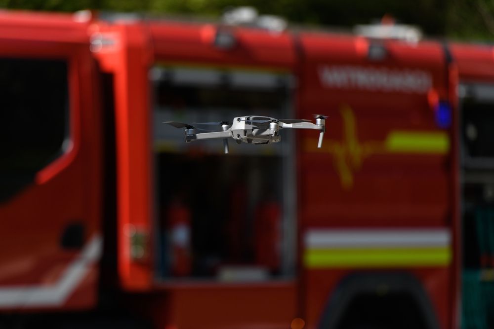 Woman in A Hat Watches a Drone Spray Crops in A Field at Sunset — Jetstream Aerial Services in Te Kowai, QLD