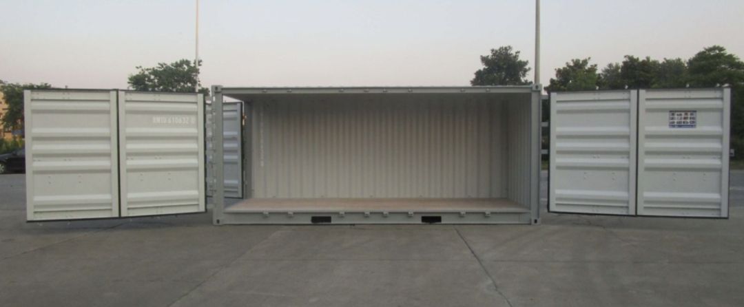 Open, empty shipping container on a concrete surface with doors fully opened to both sides.