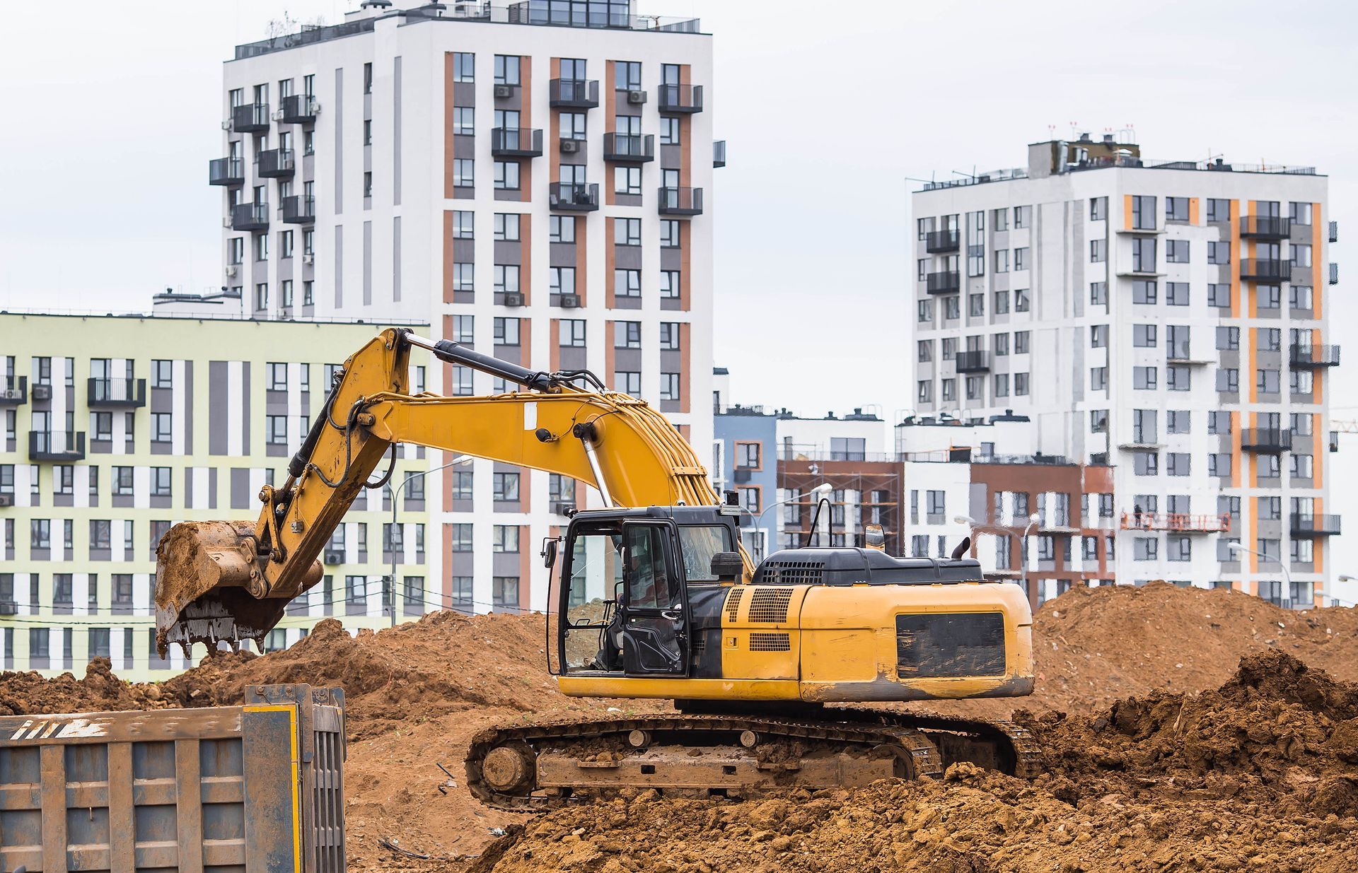 An excavator on a construction site in close-up. An excavator on a construction site in close-up.