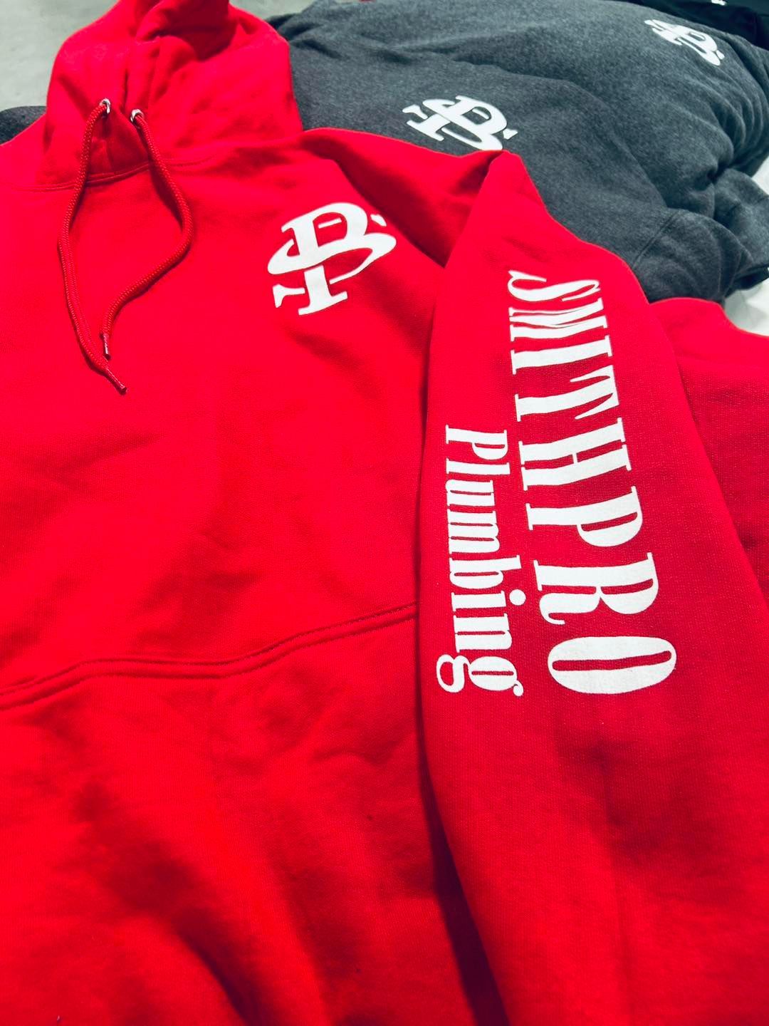 Red sweatshirt with white logo of