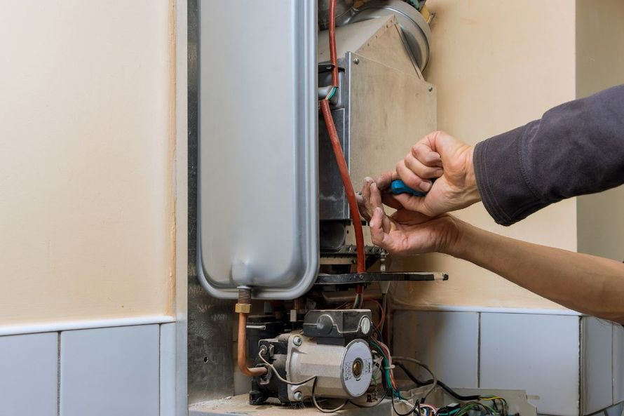 Licensed plumber repairing a residential water heater in Los Angeles and Pico Rivera